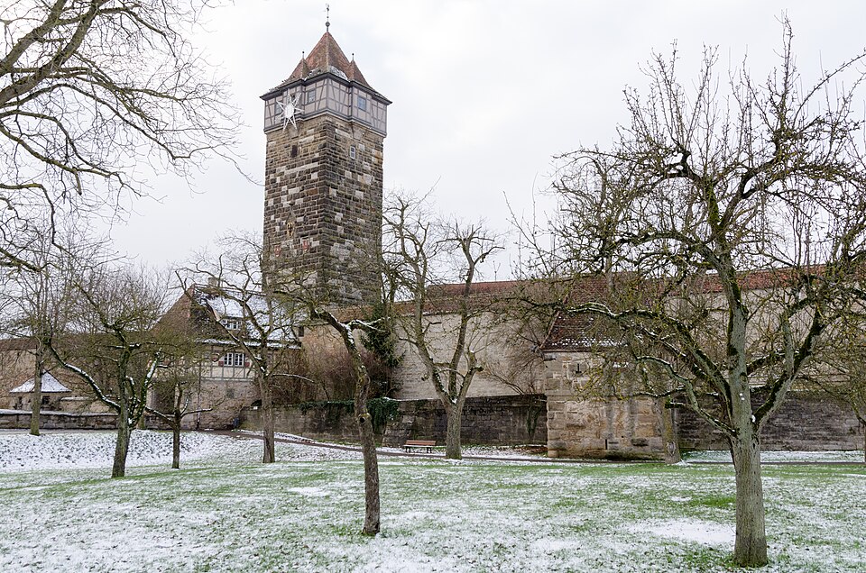 The tall Röder gate tower and the covered wall walk of Rothenburg's medieval town wall.
